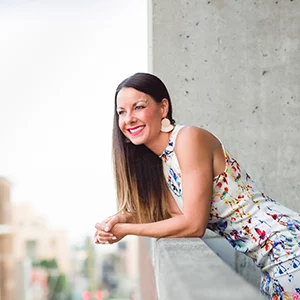 Wellness Center Frisco TX Shannyn Pearce Leaning On Balcony